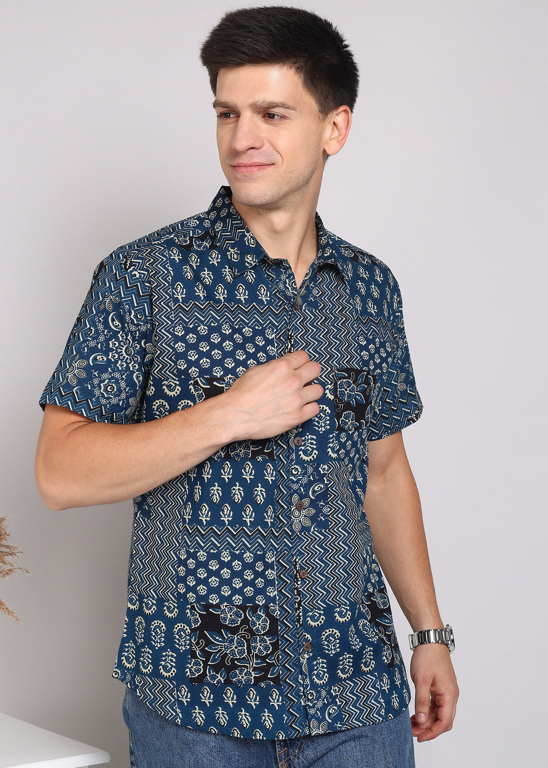 Man wearing a blue patterned shirt 